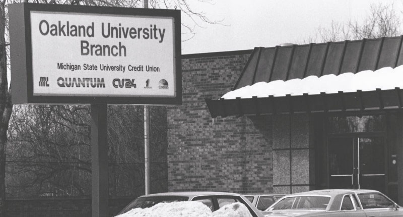 Black and white photo showing the first sign outside the Oakland University Branch of MSUFCU