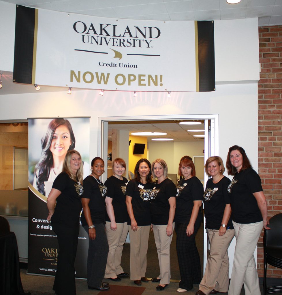 Credit Union employees stand outside the Oakland University Credit Union branch located inside OU's Oakland Center.