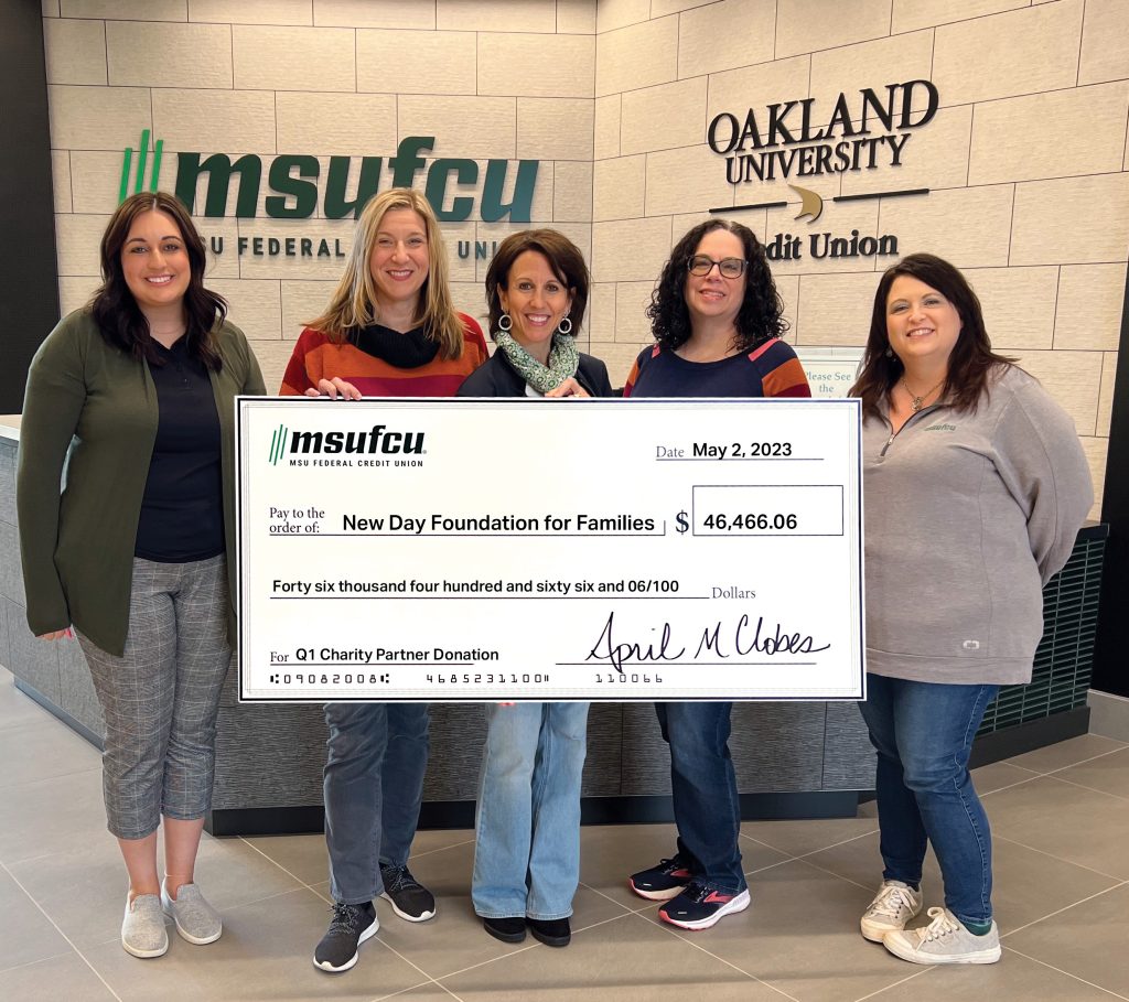 Credit Union employees present a check for over $46,000 to the New Day Foundation for Families.