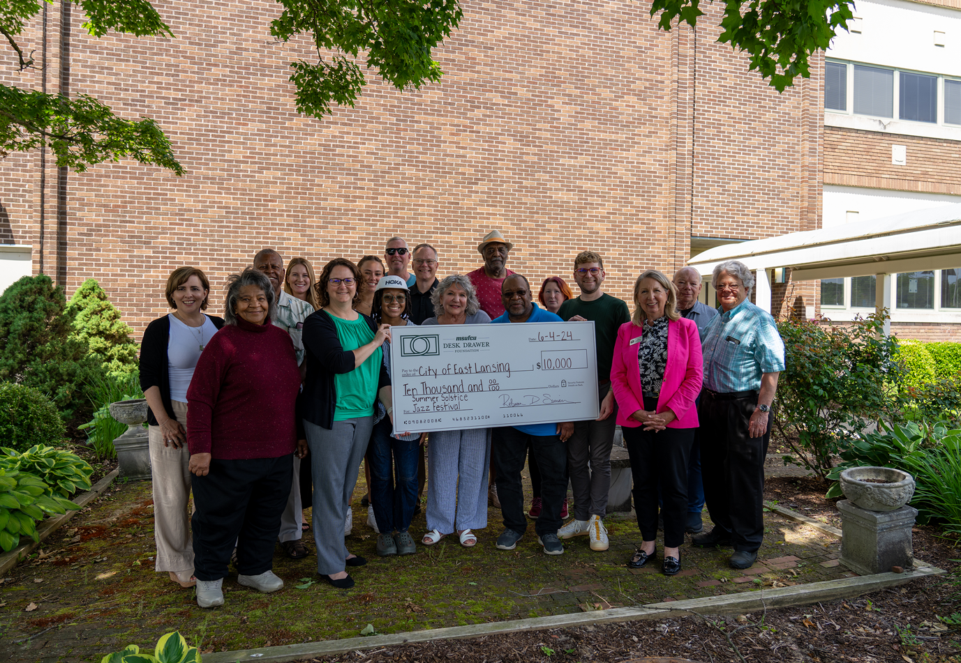 The City of East Lansing is presented with a check for the Summer Solstice Jazz Festival.